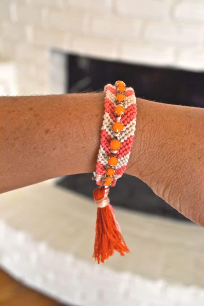 Finished friendship bracelet on a wrist.